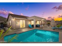 Inviting backyard pool with covered patio, outdoor seating, and mountain views provides a serene retreat at 6106 W Spur Dr, Phoenix, AZ 85083