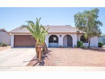 Charming single-story home with arched entry, desert landscaping, and a spacious two-car garage at 17810 N 34Th Pl, Phoenix, AZ 85032