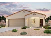 Charming single-story home featuring a neutral color palette, tile roof, and a well-manicured desert landscape at 24611 W Hilton Ave, Buckeye, AZ 85326