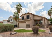 Charming two-story home featuring a well-manicured front yard and desert landscaping at 3033 E Millbrae Ln, Gilbert, AZ 85234