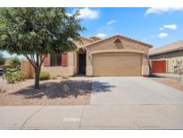 Inviting single-story home with a two-car garage and mature tree in a well-maintained front yard at 1380 W Angus Rd, San Tan Valley, AZ 85143