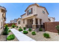 Charming two-story home featuring a welcoming front porch and well-maintained landscaping at 14241 W Bronco Trl, Surprise, AZ 85387