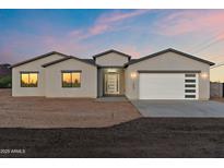 Charming single-story home with a modern design, desert landscaping, and a two-car garage at 15582 W Jomax Rd, Surprise, AZ 85387