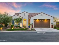 Inviting single-story home with desert landscaping, charming curb appeal, and a two-car garage at 16987 W Princeton Ave, Goodyear, AZ 85395