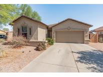Charming single-story home featuring a low-maintenance desert landscape and a two-car garage at 17056 W Bristol Ln, Surprise, AZ 85374