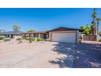 Charming single-story home featuring a two-car garage, desert landscaping, and a well-maintained front yard at 2446 E Hale St, Mesa, AZ 85213