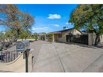 Charming single-story home with a well-kept front yard, featuring a spacious driveway and beautiful landscaping at 2601 N 51St St, Phoenix, AZ 85008