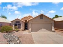 Charming single-story home featuring a two-car garage, desert landscaping, and a tile roof at 316 W Kelton Ln, Phoenix, AZ 85023