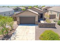 Charming single-story home featuring a two-car garage, desert landscaping, and stone accents on the facade at 3611 E Archer Dr, San Tan Valley, AZ 85140