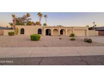 Attractive home with manicured desert landscaping, offering curb appeal and a welcoming entrance at 6639 E Pershing Ave, Scottsdale, AZ 85254