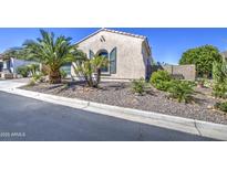 Charming single-story home featuring a low-maintenance yard with desert landscaping and rock groundcover at 14304 W Coronado Rd, Goodyear, AZ 85395