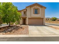 Charming two-story home with a well-maintained front yard and a two-car garage at 16935 W Central St, Surprise, AZ 85388