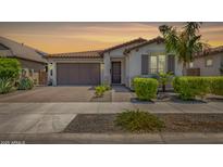 Charming single-story home with desert landscaping, a tile roof, and a paver driveway at 20891 E Cattle Dr, Queen Creek, AZ 85142