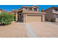 Charming two-story home features a tile roof, two-car garage, and low maintenance desert landscaping at 26235 N 45Th Pl, Phoenix, AZ 85050