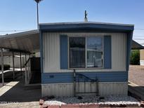 Charming single-story manufactured home with a cozy carport and well-maintained landscaping at 530 S Alma School Rd # 50, Mesa, AZ 85210
