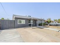 Charming single-story home with a covered entry and driveway with parking at 6147 W Rose Cir, Phoenix, AZ 85033