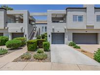 Stylish townhome complex featuring modern design, private garages, and manicured landscaping at 7710 E Gainey Ranch E Rd # 115, Scottsdale, AZ 85258