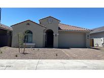 Charming single-story home with a low-maintenance landscaped front yard and a two car garage at 10217 W Fairmount Ave, Avondale, AZ 85392