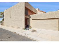 Beige two-story home featuring an attached two car garage, and a neutral desert landscape at 7756 N 19Th Ln, Phoenix, AZ 85021