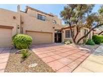 Charming two-story home with a two-car garage, desert landscaping, and a tile roof at 7955 E Chaparral Rd # 17, Scottsdale, AZ 85250