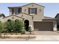 Charming two-story home with a well-maintained yard and a paved driveway leading to a two-car garage at 9548 E Rainbow Ave, Mesa, AZ 85212