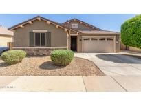 Inviting single-story home with desert landscaping and a two-car garage at 15719 W Laurel Ln, Surprise, AZ 85379