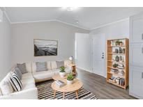 Bright living room with modern decor, featuring a white sofa and stylish round tables at 320 E Mckellips Rd # 195, Mesa, AZ 85201