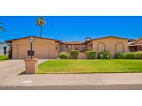 Charming single-level home featuring a manicured lawn, attached garage, and desert landscaping at 3659 W Windrose Dr, Phoenix, AZ 85029