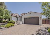 Charming stucco home with a two-car garage and well-manicured landscaping at 4135 E Grand Canyon Dr, Chandler, AZ 85249