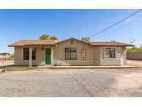 Charming single-story home with a brown roof, green door, and a spacious gravel front yard at 44446 N 14Th St, New River, AZ 85087