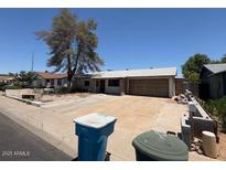 Single level home with desert landscaping and a two car garage at 18415 N 33Rd Ave, Phoenix, AZ 85053
