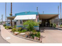 Charming manufactured home featuring a carport, manicured landscaping, and a welcoming curb appeal at 4065 E University Dr # 76, Mesa, AZ 85205