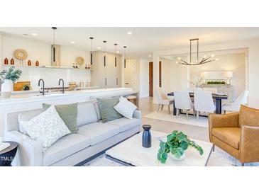 Bright living room features a modern open floor plan connecting living, dining, and kitchen spaces at 600 N Roxboro St # 24, Durham, NC 27701