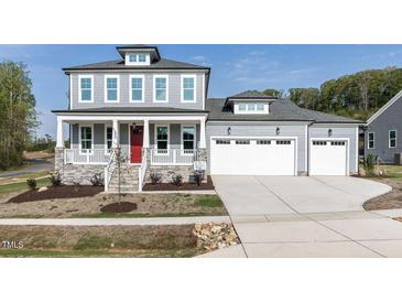 Charming two-story home with a welcoming front porch and attached two-car garage at 6060 Scalybark Rd, Durham, NC 27712