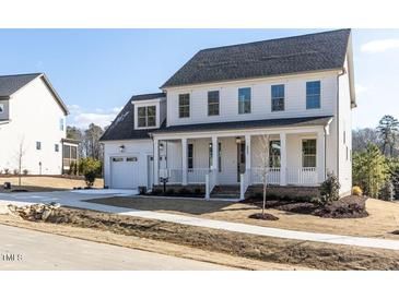 Two-story white house with gray roof, front porch, and two-car garage at 6063 Scalybark Road, Durham, NC 27712