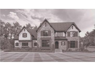 Charming two-story home with stone exterior, well-manicured lawn, and inviting front entrance at 102 Peddler Ml Way # 23, Pittsboro, NC 27312