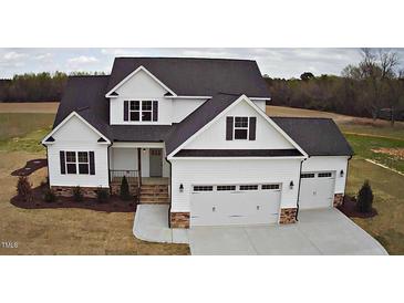 Charming two-story home features a large garage and well-manicured lawn in a quiet neighborhood at 98 Prency Ln, Middlesex, NC 27557