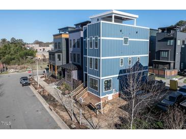 Striking three-story home featuring modern design and a rooftop terrace in a vibrant neighborhood at 618 Velma Hopkins Ln, Raleigh, NC 27603