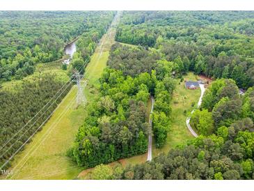 Secluded home site accessible via long driveway and surrounded by lush green trees, offering privacy and natural beauty at 2723 New Sharon Church Rd, Hillsborough, NC 27278