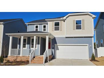 Two-story home with gray siding, red door, and a white garage door at 1341 Underbrush Dr, Durham, NC 27703