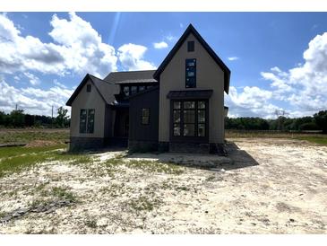 New two-story home featuring a modern design and neutral color palette at 4905 Hidden Pasture Way, Zebulon, NC 27597