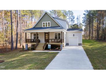 Charming two-story home with a welcoming front porch and well-manicured lawn at 158 Nakoma Dr, Louisburg, NC 27549