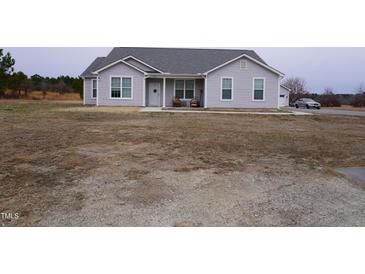 Ranch style home with gray siding, attached garage, and a spacious yard at 1850 Gillburg Road, Henderson, NC 27537