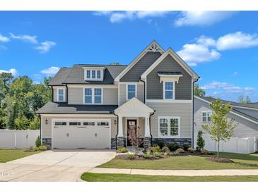 Charming two-story home with a manicured lawn, stone accents, and an attached two-car garage at 9113 Dupree Meadow Dr # 41, Angier, NC 27501