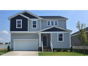 Two-story house with gray siding, white trim, and a two-car garage at 805 Emmer St, Rolesville, NC 27571