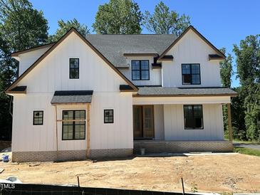 New construction: Charming two-story home featuring white siding, black-framed windows, and a welcoming front porch at 28 Bar Code Ct, Wendell, NC 27591