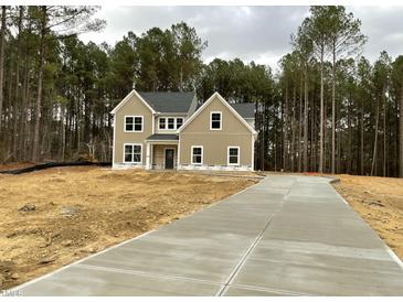 Two story house with gray siding and a long driveway at 73 Artic Cir, Garner, NC 27529