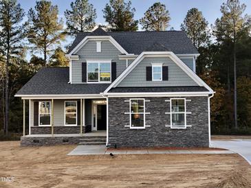 Two-story house with gray siding, stone accents, and a covered porch at 35 Long Needle Ct # 36, Youngsville, NC 27596