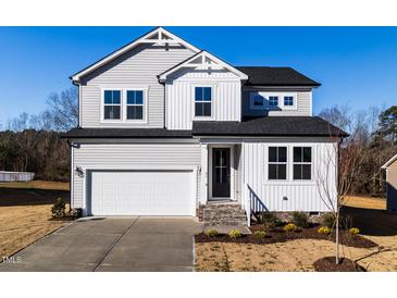 Two-story house with gray siding, white trim, and a two-car garage at 395 Fast Pitch Ln, Four Oaks, NC 27524