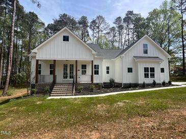 Charming single-Gathering home featuring a beautifully landscaped yard and inviting front porch at 30 Tamaran Ct, Spring Hope, NC 27882